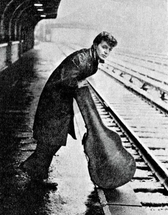 Musician beside a railway track