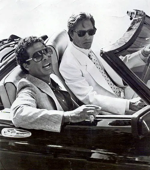 Two men riding in a convertible